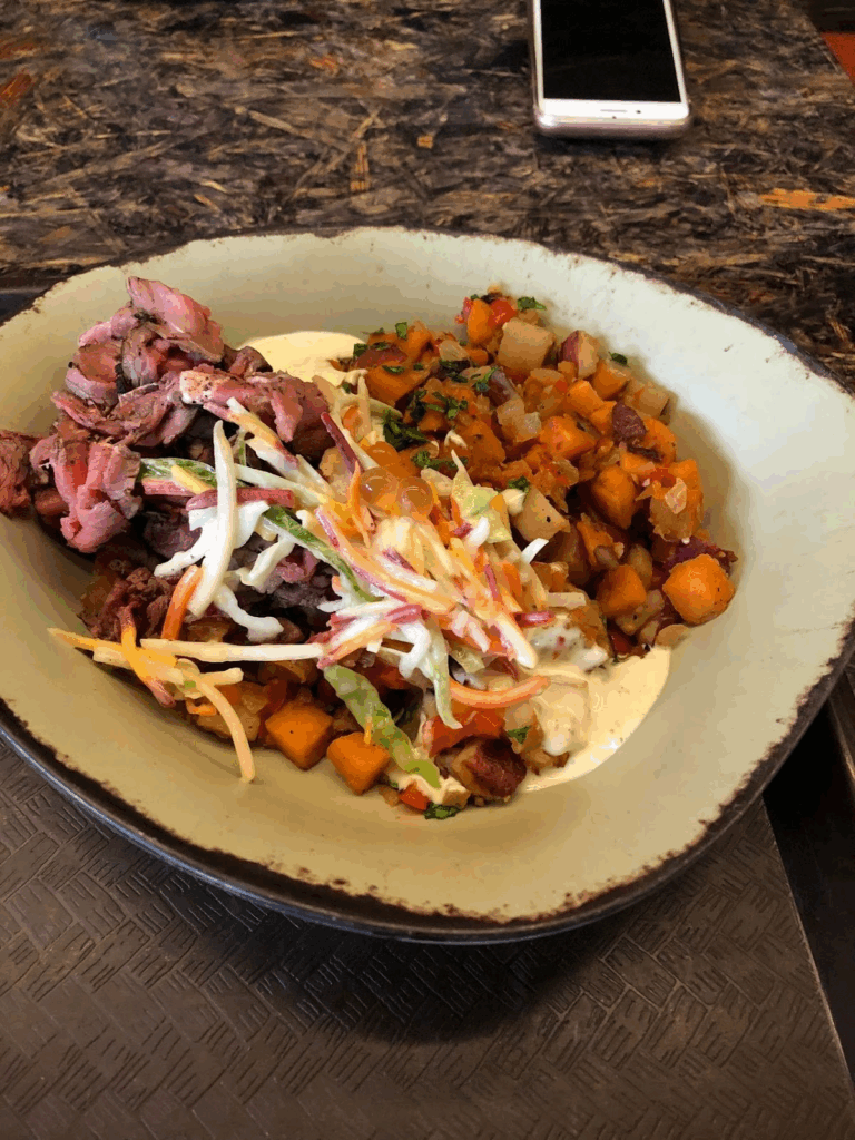 The Slow-Roasted Sliced Grilled Beef Bowl over sweet potato hash with Creamy Herb Dressing. $17.49
